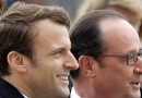 Deux responsables politiques français photographiés de profil côte à côte lors d’un événement officiel en extérieur, l’un souriant légèrement, l’autre portant des lunettes, avec un arrière-plan flou.