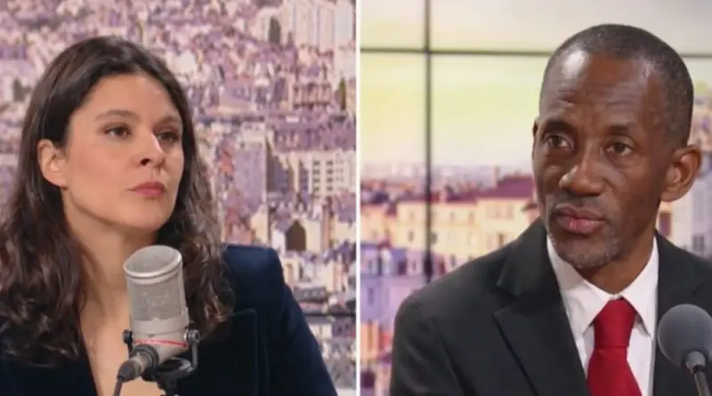 journaliste en plateau télévision face à un élu politique lors d’une interview tendue en direct avec microphones visibles