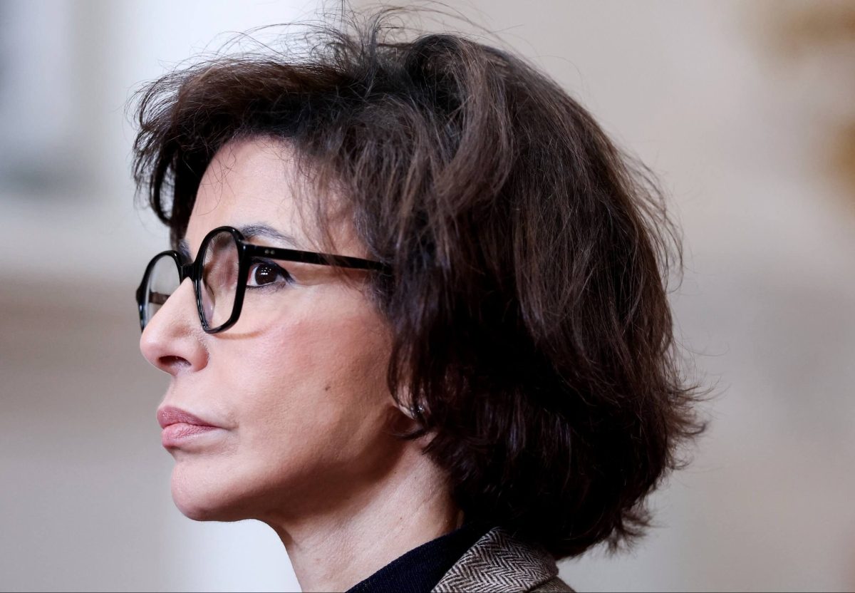Portrait de profil d’une femme politique française portant des lunettes, le visage sérieux et concentré, dans un contexte d’actualité politique et de polémique médiatique.