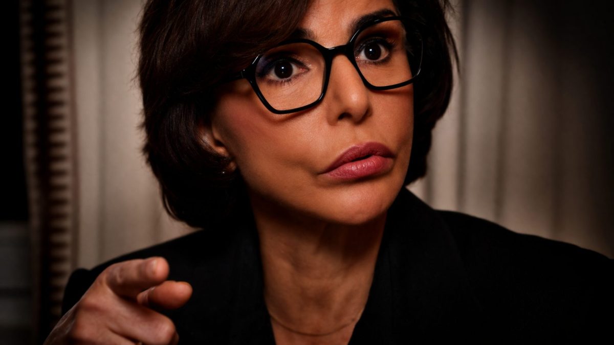 Portrait rapproché d’une femme politique au regard intense et direct, portant des lunettes noires, expression sérieuse et déterminée, éclairage contrasté mettant en valeur les yeux, arrière-plan flou, ambiance tendue et dramatique évoquant une confrontation ou un moment de pression politique