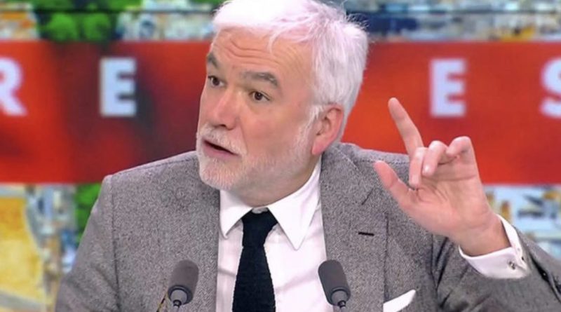 animateur de télévision en plein débat sur un plateau d’information levant la main face aux caméras dans une ambiance tendue de direct télévisé