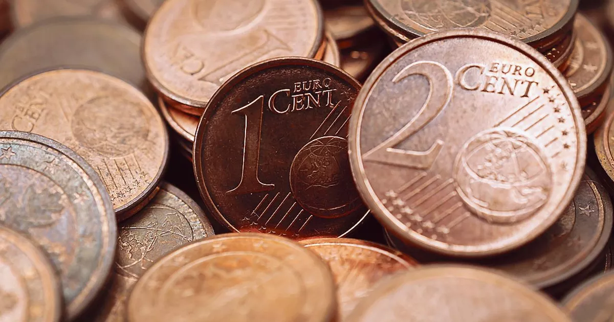 Gros plan sur plusieurs pièces de centimes en euro empilées et dispersées, avec une pièce de 1 centime et une pièce de 2 centimes bien visibles au centre, illustration de la monnaie européenne et des pièces rares recherchées en numismatique