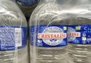 Packs de bouteilles d'eau Cristaline emballés dans un film plastique transparent, illustrant le débat autour du règlement européen PPWR et de la réduction des emballages plastiques à usage unique à partir de 2026.