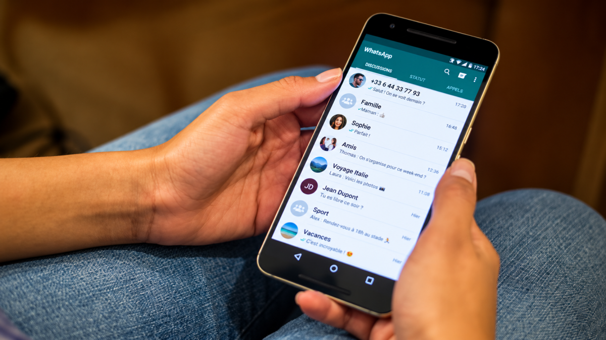 Personne utilisant WhatsApp sur un smartphone Android, illustration des changements de compatibilité de WhatsApp avec les anciens téléphones en 2026.