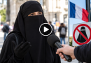 Illustration montrant une femme portant un niqab noir interrogée dans une rue en France, avec un microphone tendu vers elle, un drapeau français et un panneau symbolisant l’interdiction du voile intégral. L’image illustre un article consacré au témoignage d’une Française convertie à l’islam affirmant porter le voile intégral pour échapper au regard des hommes et préférer rester chez elle si elle ne pouvait plus le porter dans l’espace public.